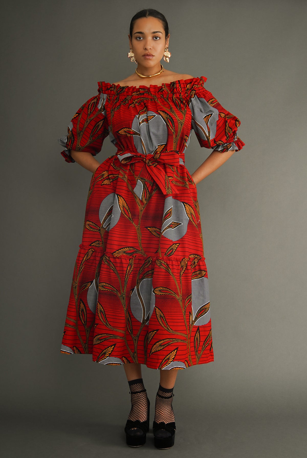 Efe off-shoulder dress in red Dutch wax print, oversized fit with belted waist, front view