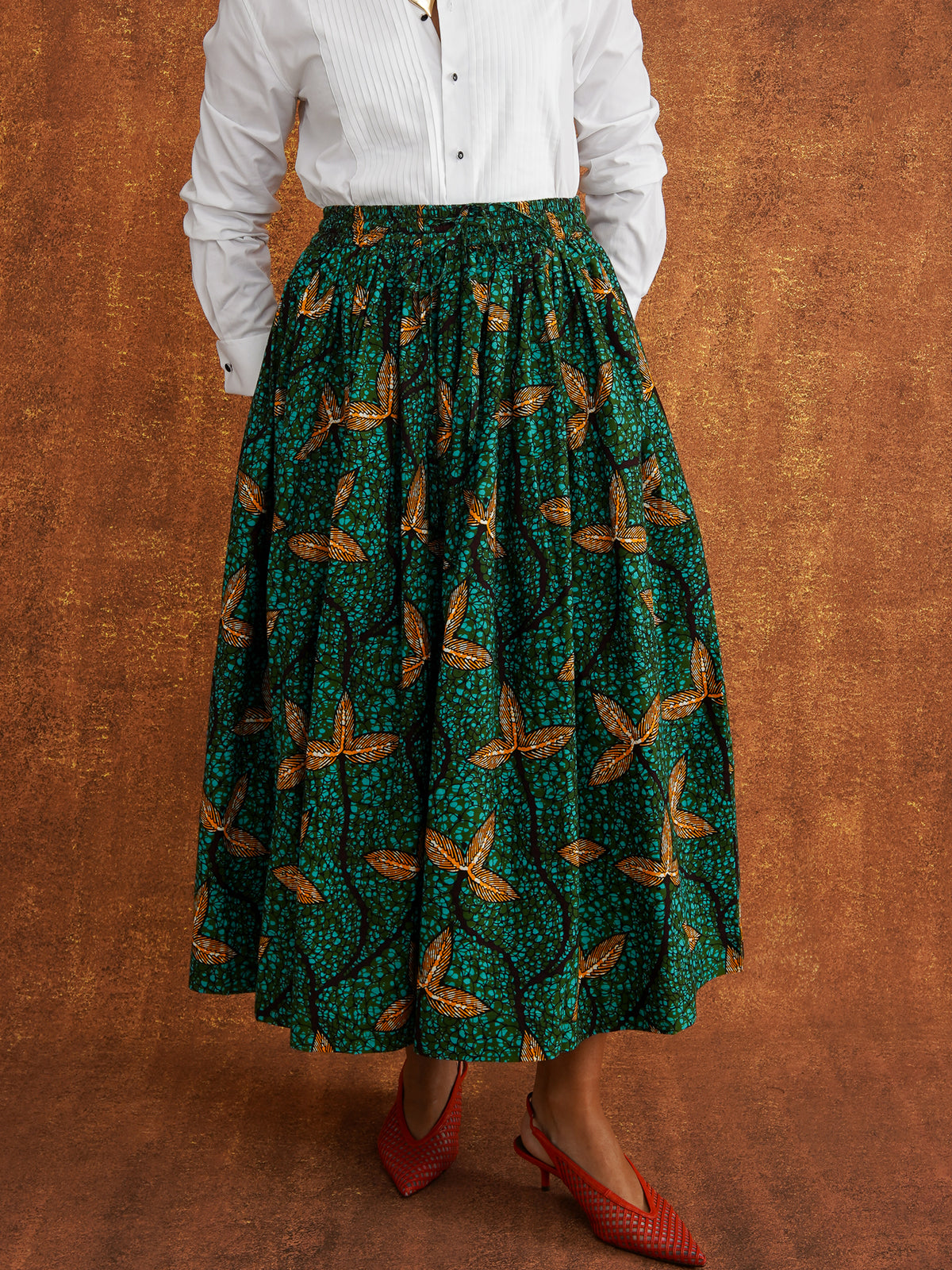 Close view of Tanna's gathered waist and green Dutch wax print