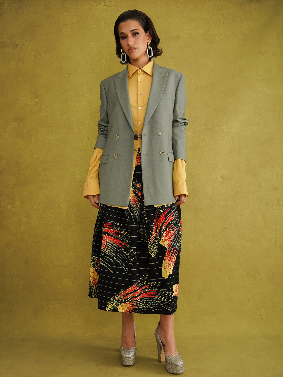 Ariya Cotton Midi Skirt, a tulip-shaped midi skirt in red and yellow Fireworks print Dutch wax cotton on a blue background