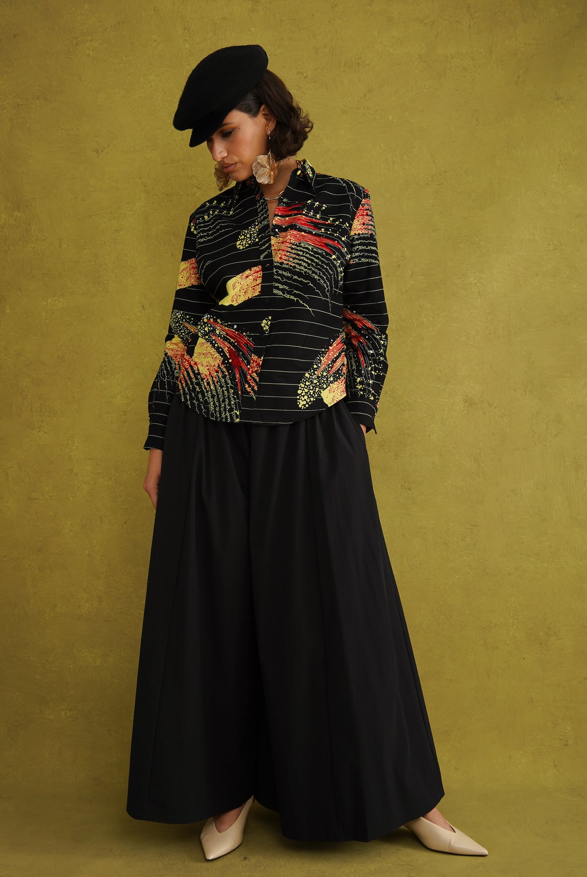 Ariya Adaze Shirt, a fitted shirt in red and yellow Fireworks print Dutch wax cotton on a blue background