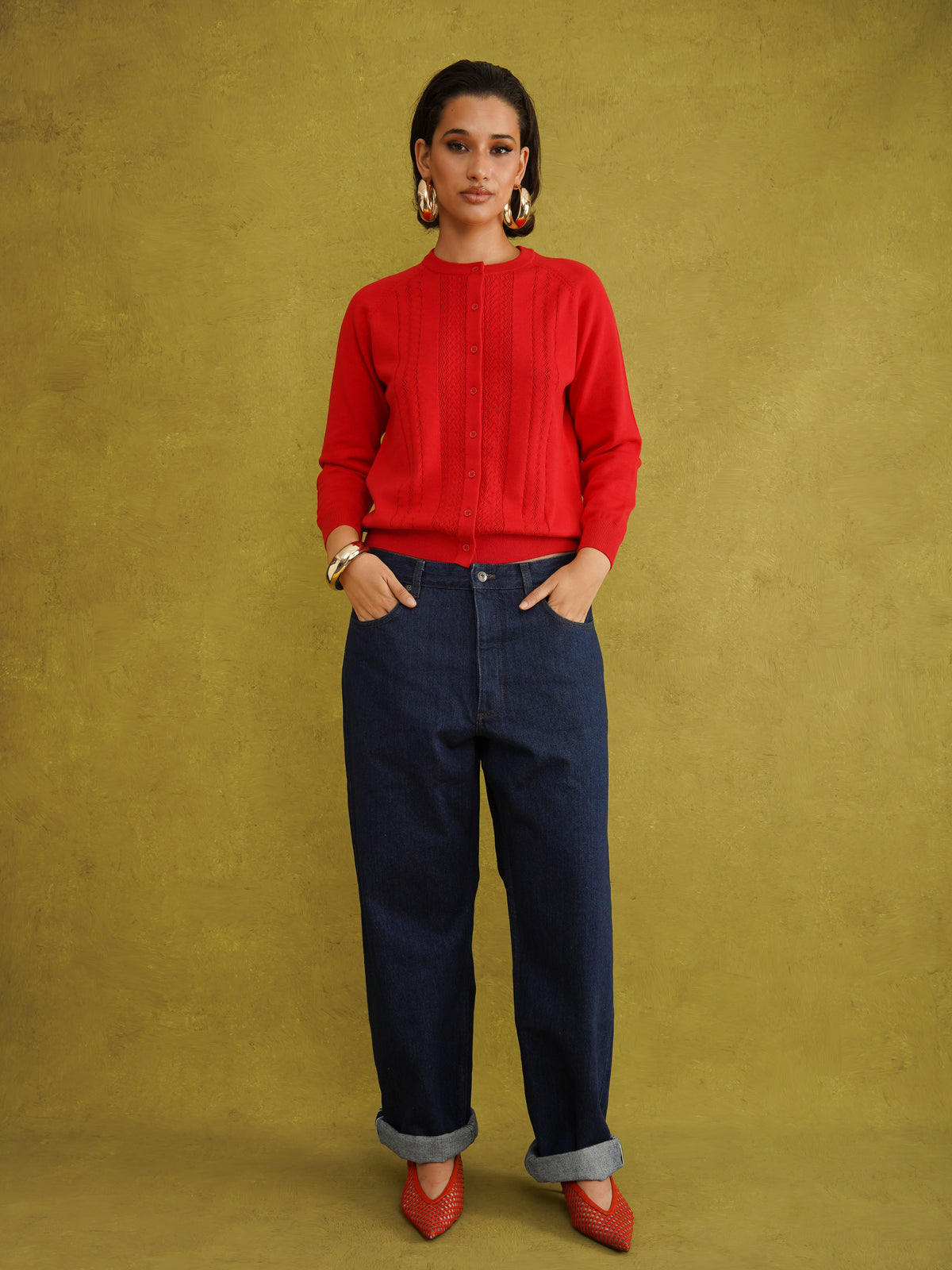 Titi Cardigan in Red, a relaxed-fit red knit cardigan with open-work and cable stitches and small buttons up to the neck
