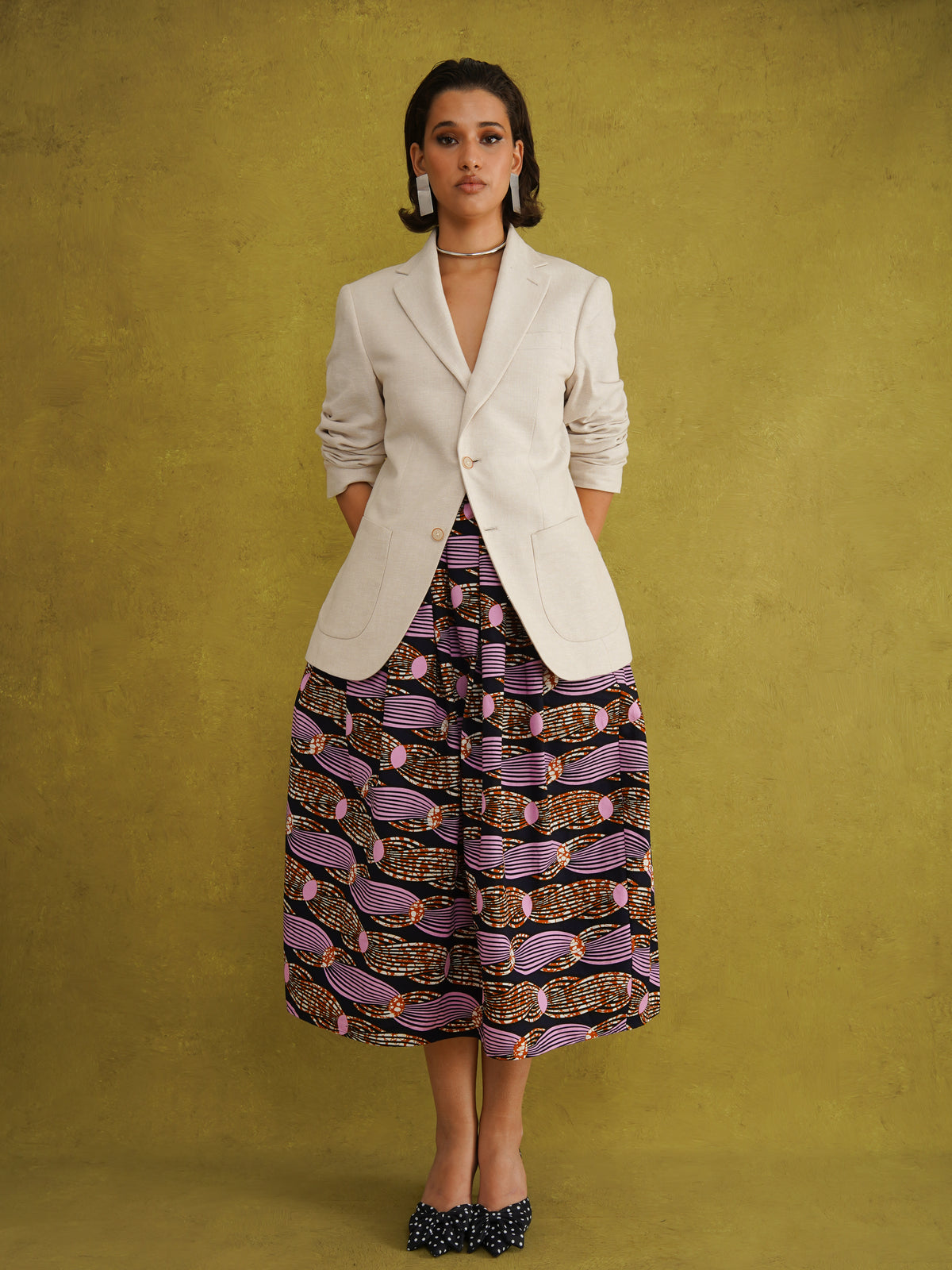 Irawo Cotton Midi Skirt, a tulip-shaped midi skirt in pink and orange shooting-star print Dutch wax cotton on a deep navy background