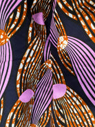 Irawo Cotton Midi Skirt, a tulip-shaped midi skirt in pink and orange shooting-star print Dutch wax cotton on a deep navy background