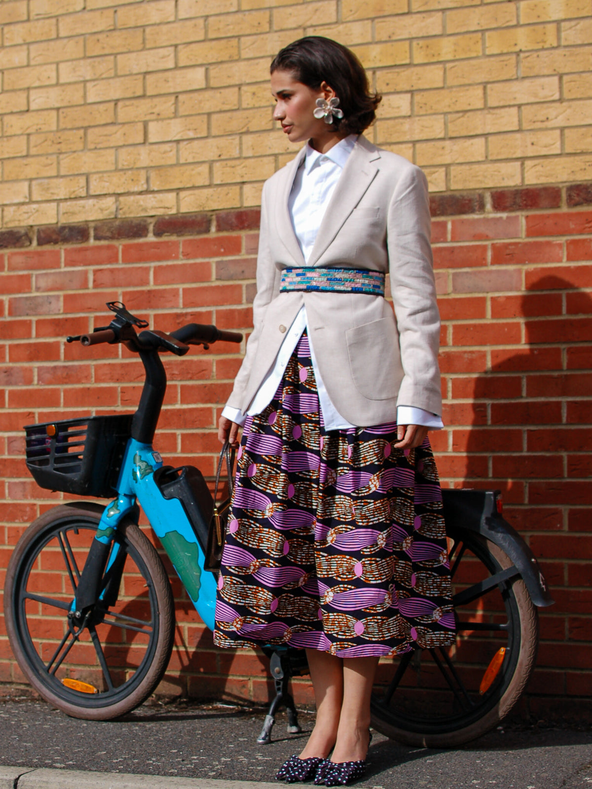 Irawo Cotton Midi Skirt, a tulip-shaped midi skirt in pink and orange shooting-star print Dutch wax cotton on a deep navy background