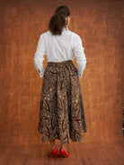 Back view of the Chinaza Dutch wax cotton midi skirt worn with a white shirt
