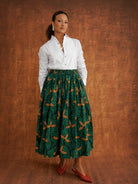 Tanna gathered cotton skirt styled with a white shirt and red pointed flats