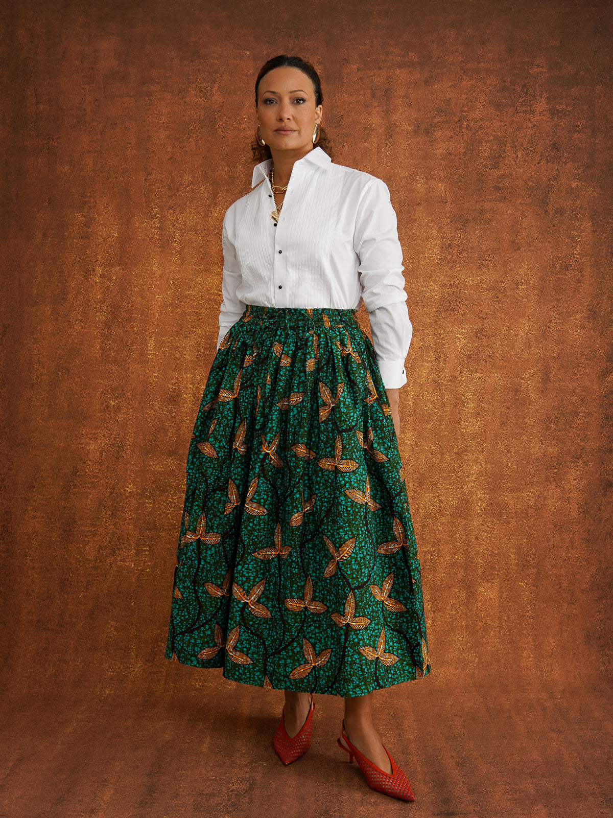 Tanna green Dutch wax skirt styled with a white shirt, showing its full shape