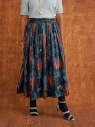 Front detail of the KemKem Abstract Midi Skirt showing the belt, gathered waist and colourful print