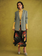 Ariya Cotton Midi Skirt, a tulip-shaped midi skirt in red and yellow Fireworks print Dutch wax cotton on a blue background