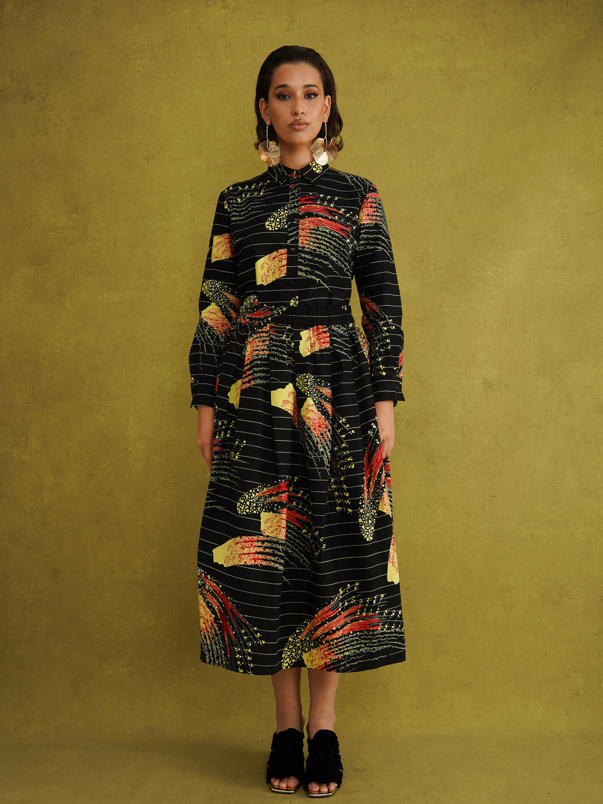 Ariya Adaze Shirt, a fitted shirt in red and yellow Fireworks print Dutch wax cotton on a blue background