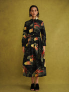 Ariya Cotton Midi Skirt, a tulip-shaped midi skirt in red and yellow Fireworks print Dutch wax cotton on a blue background