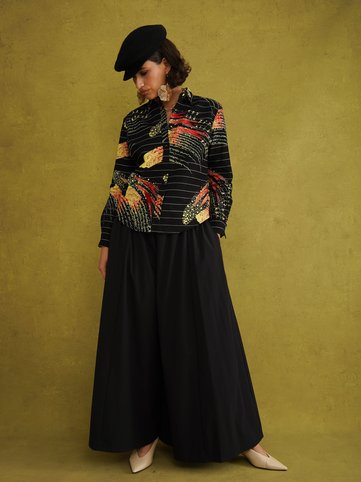 Ariya Adaze Shirt, a fitted shirt in red and yellow Fireworks print Dutch wax cotton on a blue background