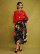 Titi Cardigan in Red, a relaxed-fit red knit cardigan with open-work and cable stitches and small buttons up to the neck