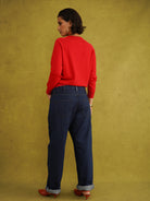 Titi Cardigan in Red, a relaxed-fit red knit cardigan with open-work and cable stitches and small buttons up to the neck
