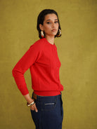 Titi Cardigan in Red, a relaxed-fit red knit cardigan with open-work and cable stitches and small buttons up to the neck