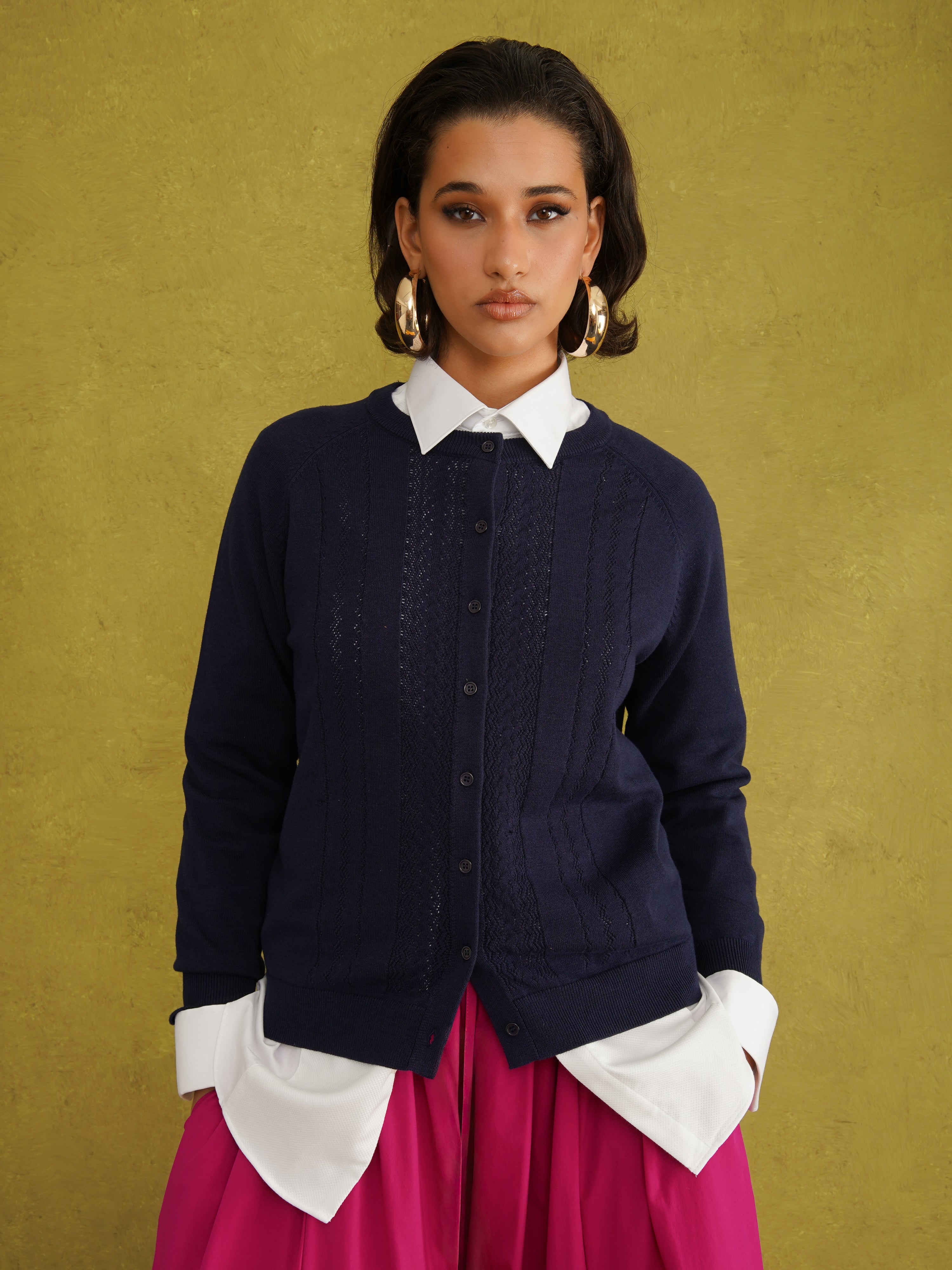 Titi Cardigan in Navy, a relaxed-fit navy knit cardigan with open-work and cable stitches and small buttons up to the neck