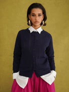 Titi Cardigan in Navy, a relaxed-fit navy knit cardigan with open-work and cable stitches and small buttons up to the neck