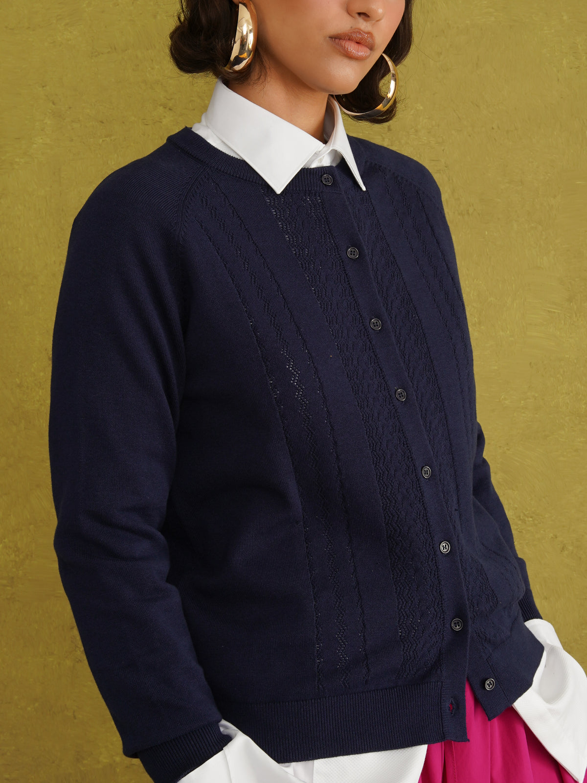 Titi Cardigan in Navy, a relaxed-fit navy knit cardigan with open-work and cable stitches and small buttons up to the neck
