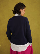 Titi Cardigan in Navy, a relaxed-fit navy knit cardigan with open-work and cable stitches and small buttons up to the neck