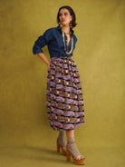 Irawo Cotton Midi Skirt, a tulip-shaped midi skirt in pink and orange shooting-star print Dutch wax cotton on a deep navy background