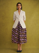 Irawo Cotton Midi Skirt, a tulip-shaped midi skirt in pink and orange shooting-star print Dutch wax cotton on a deep navy background