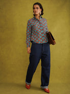 Oge Adaze Shirt, a fitted shirt in Dutch wax cotton with coral-pink bows on a bright turquoise background