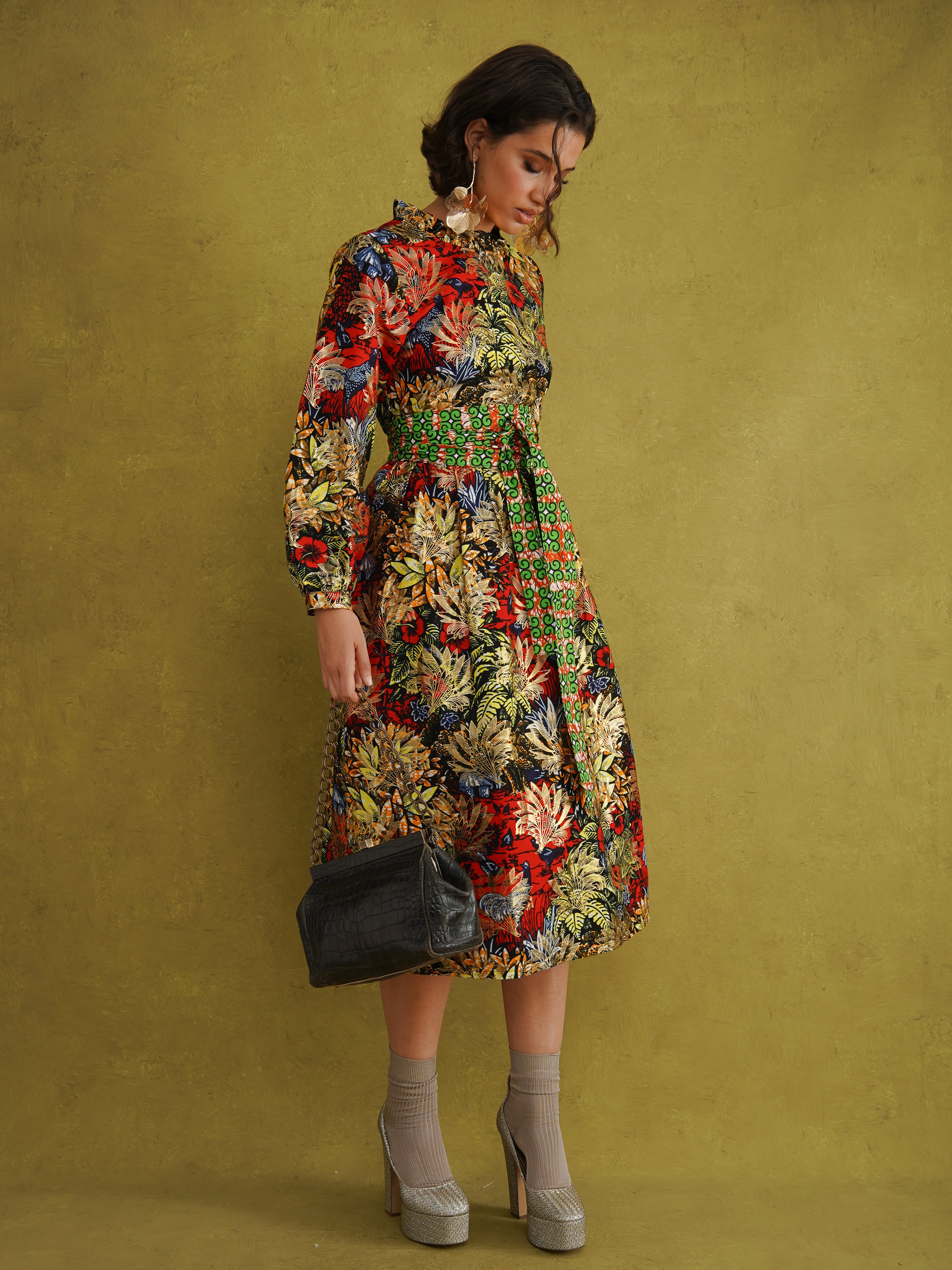 Commot for Road Golden Red Dress by Kemi Telford, a black, red and gold tropical wax print dress with a high ruffle neck and balloon sleeves
