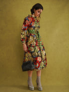Commot for Road Golden Red Dress by Kemi Telford, a black, red and gold tropical wax print dress with a high ruffle neck and balloon sleeves